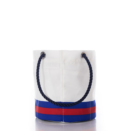 The Buffalo Bills Beverage Bucket by Sea Bags is a white, bucket-shaped bag featuring blue and red stripes at the base and a navy blue rope handle, displayed on a white background. Designed as a sustainable cooler, this versatile accessory keeps your beverages chilled while showcasing your team spirit in style. by Sea Bags