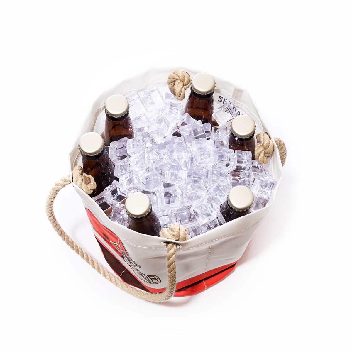 A Sea Bags Cleveland Browns Beverage Bucket made from sail cloth, featuring rope handles, holds six brown beer bottles nestled in ice cubes on a white background. by Sea Bags