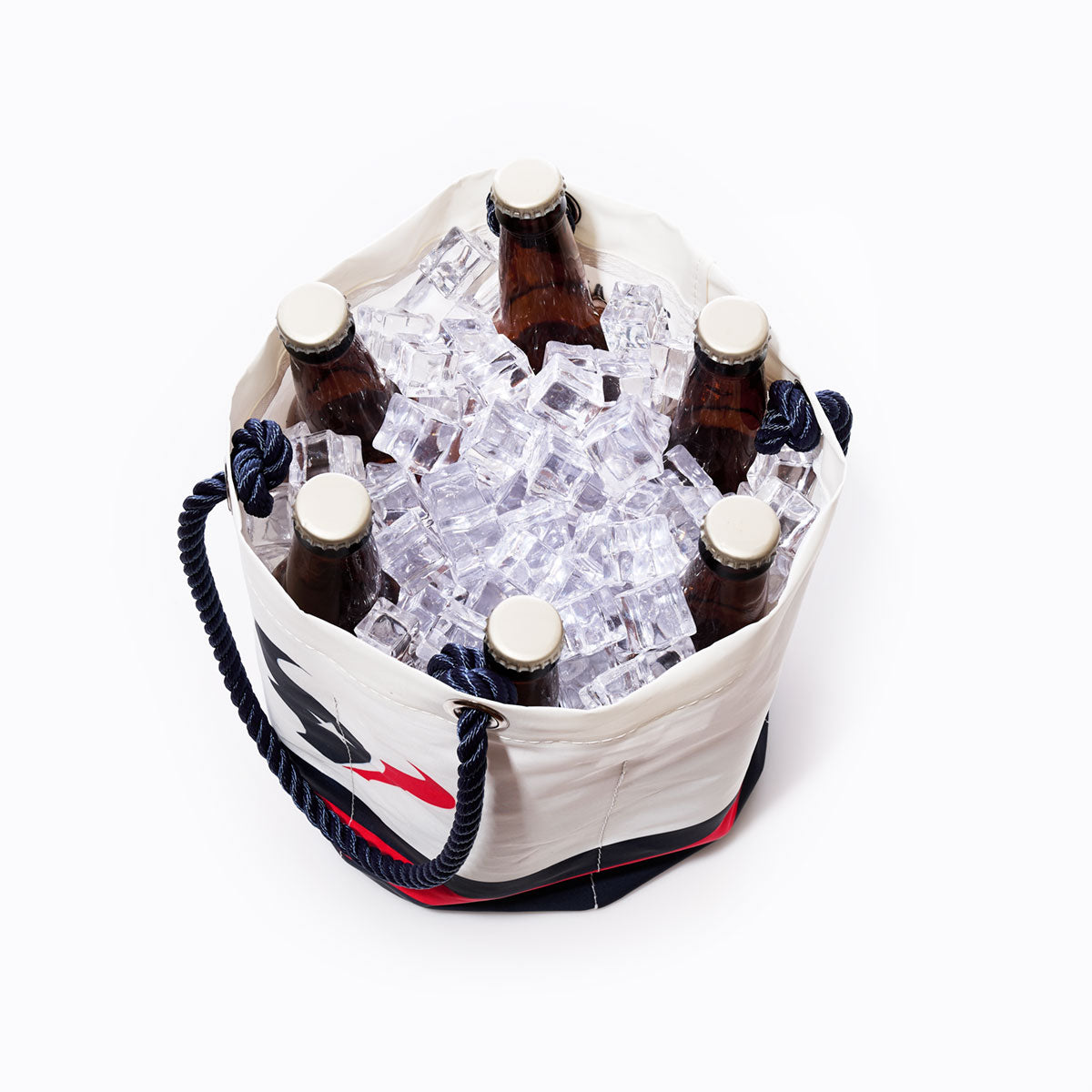 A Sea Bags Houston Texans Beverage Bucket, designed in white with sustainable materials, is filled with ice and six brown glass beer bottles, viewed from above against a plain white background. by Sea Bags
