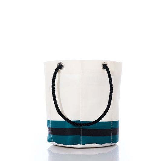 The Jacksonville Jaguars Beverage Bucket by Sea Bags is a white bucket bag accented with black and teal stripes at the bottom—echoing the teams iconic colors. It features a thick black rope handle and is photographed against a white background. by Sea Bags