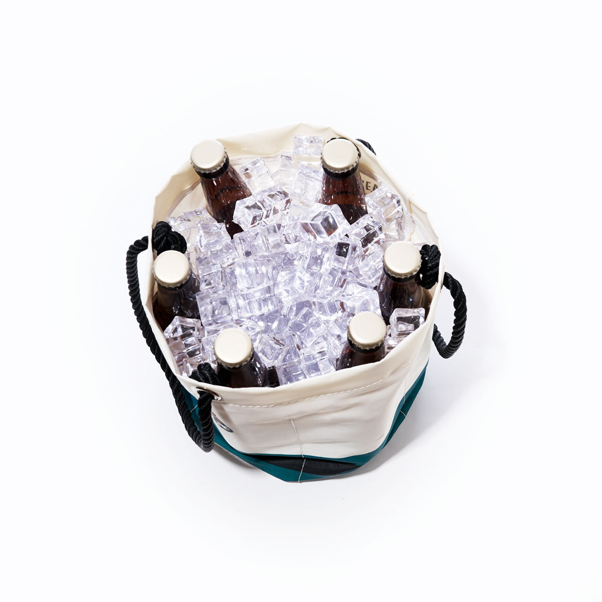 Six brown glass bottles sit upright among ice cubes inside the Sea Bags Jacksonville Jaguars Beverage Bucket—a round, white and green sustainable cooler with black rope handles—viewed from above on a white background. by Sea Bags