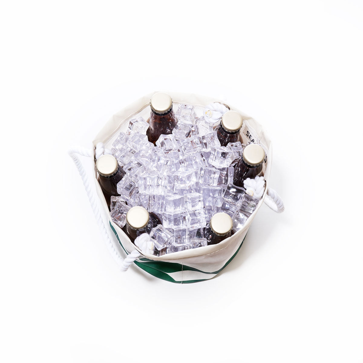 Six brown glass bottles are placed upright in a Sea Bags New York Jets Beverage Bucket filled with clear ice cubes, viewed from above against a white background. by Sea Bags