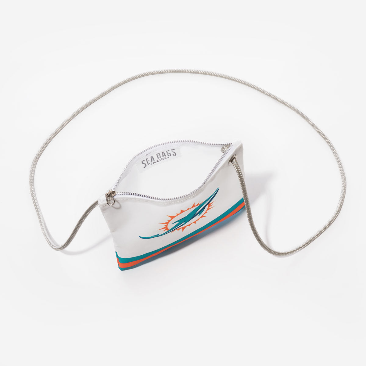 The Sea Bags Miami Dolphins Slim Crossbody is a white pouch crafted from recycled sail cloth, featuring the team’s logo, a silver zipper, and a chain strap—photographed on a white background for fans who value both sustainable design and standout style. by Sea Bags
