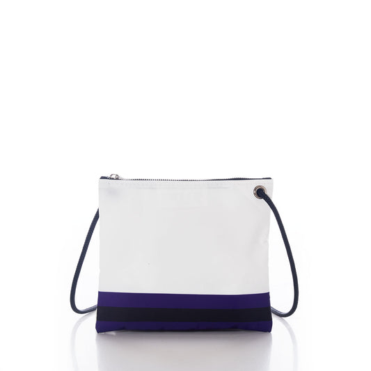 The Sea Bags Baltimore Ravens Slim Crossbody is a white bag crafted from recycled sail cloth, featuring a distinctive black and navy blue stripe near the bottom, a zip closure at the top, and a dark shoulder strap, displayed on a white background. by Sea Bags