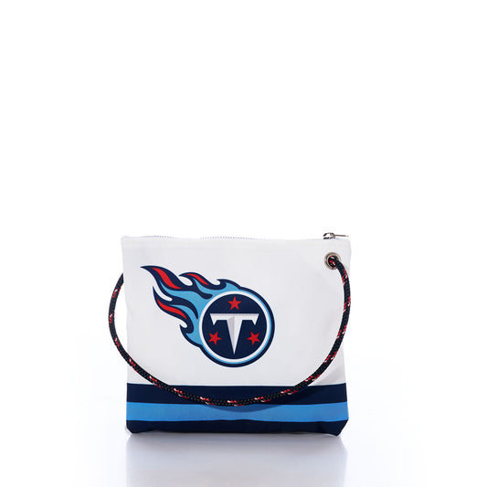 Show off your Titans NFL pride sustainably with the Sea Bags Tennessee Titans Slim Crossbody. Crafted from recycled sail cloth for a unique touch, this white crossbody bag features bold blue stripes and the official Tennessee Titans logo. It boasts a black and red rope strap and zippered closure, combining eco-friendly style with practical design. by Sea Bags