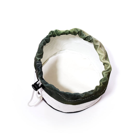 The Sea Bags Dragon Skin Ditty Bag is a sustainable fabric drawstring bag featuring a green and white color scheme, pictured from above with its opening fully expanded—thoughtfully designed to combine eco-conscious practicality with stylish appeal. by Sea Bags