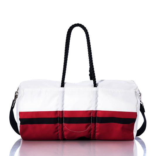The Atlanta Falcons Duffel by Sea Bags is crafted from recycled sail cloth in white, featuring red and black horizontal stripes, two black rope handles, and a detachable black shoulder strap, displayed on a reflective surface. by Sea Bags