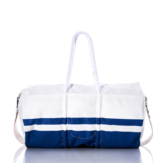 Introducing the Indianapolis Colts Duffel by Sea Bags—crafted from recycled sail cloth in white and blue, with rope handles and a shoulder strap. Displayed on a reflective surface against a white background, this bag is the perfect blend of style and sustainability for Indianapolis Colts fans. by Sea Bags