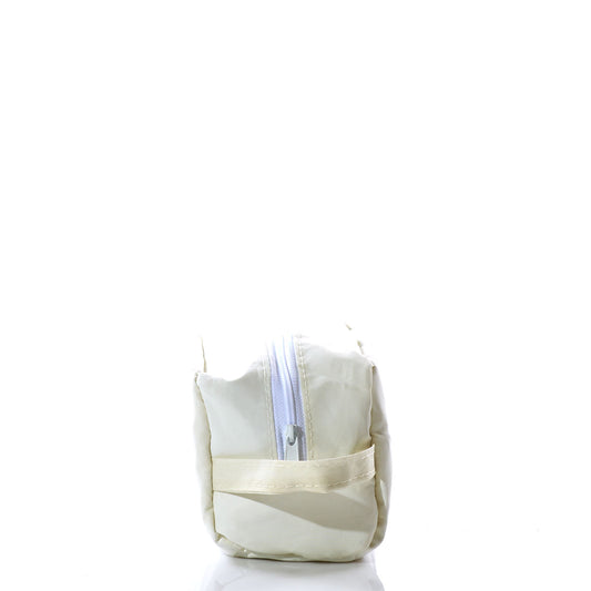A Navy Anchor Toiletry Bag by Sea Bags, featuring a rectangular cream-colored design with a zipper and handle, crafted from recycled sail bags, is displayed standing upright against a white background. by Sea Bags