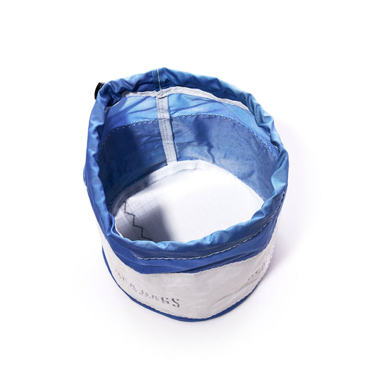 Sea Bags Ditty Bag—a blue and white collapsible fabric bowl with a reinforced rim, inspired by recycled sail bags—shown from above on a white background. This versatile piece is perfect for organization or as a modern ditty bag. by Sea Bags