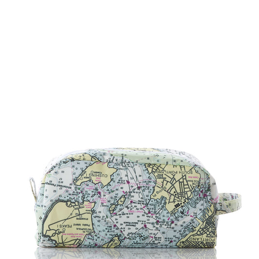 The Sea Bags Casco Bay Nautical Chart Toiletry Bag is a rectangular travel kit, made from recycled sail cloth, featuring a printed nautical map design, side strap, and zipper. Displayed against a white background, this bag is the ideal companion for your next adventure. by Sea Bags