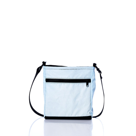 Vintage Light Blue Small Voyager Crew Crossbody by Sea Bags, sustainably crafted from recycled sail cloth, features a black adjustable strap, a black zipper pocket on the front, and black trim, shown against a white background. by Sea Bags