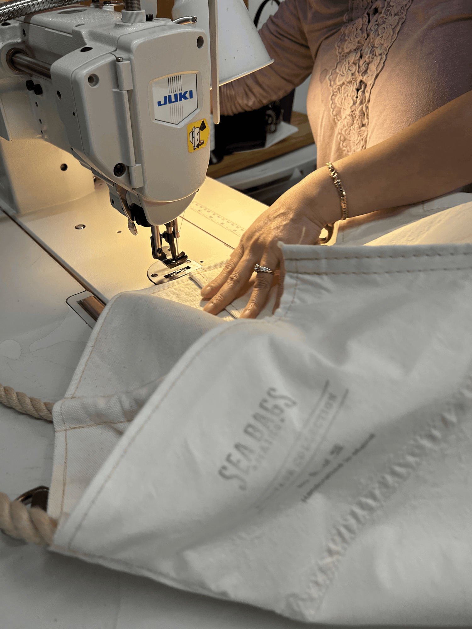 a woman sewing a sea bag tote with rope handles