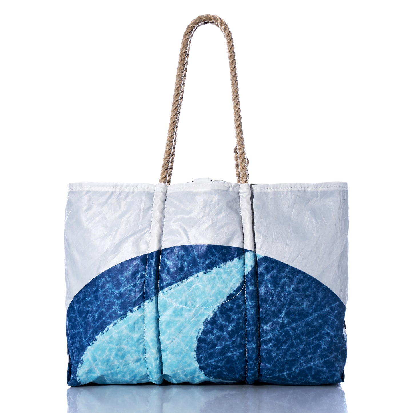 The Sea Bags Auction Sun-Washed Sailboat Large Tote, showcasing a blue and white ocean wave design and rope handles, is photographed against a white background.