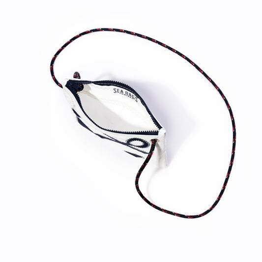 Sea Bags Navy Anchor Slim Crossbody Bag featuring a black anchor design on white sail cloth, a slim silhouette, and a thin, multicolored adjustable strap, photographed from above on a white background. by Sea Bags