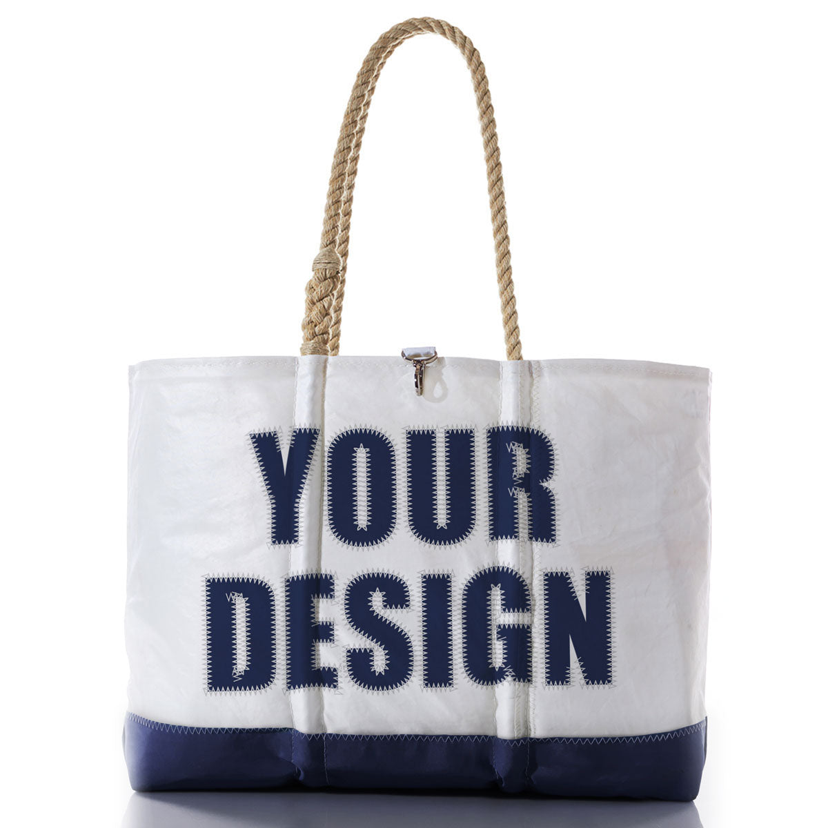 The Sea Bags Custom Design Ogunquit Beach Tote is a white and navy beach bag with rope handles, featuring YOUR DESIGN printed in large, bold blue letters on the front—an ideal personalized accessory crafted for both style and convenience. by Sea Bags
