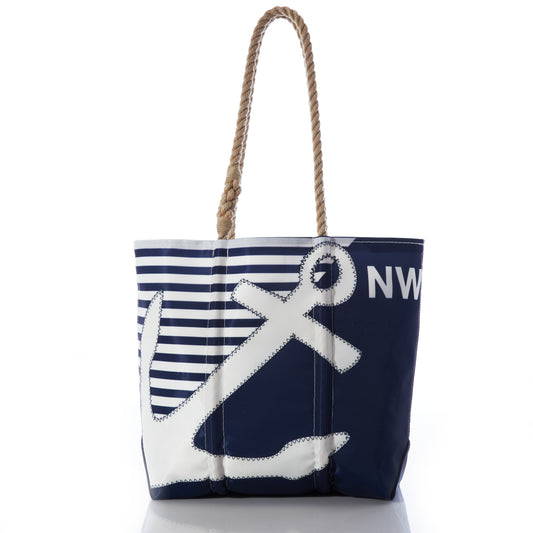 Sea Bags Custom Monogram Breton Stripe Anchor Medium Tote, crafted from recycled sail cloth, features a navy blue and white striped panel, a bold anchor design, and rope handles. Photographed on a white background, this personalized tote is both stylish and eco-friendly. by Sea Bags