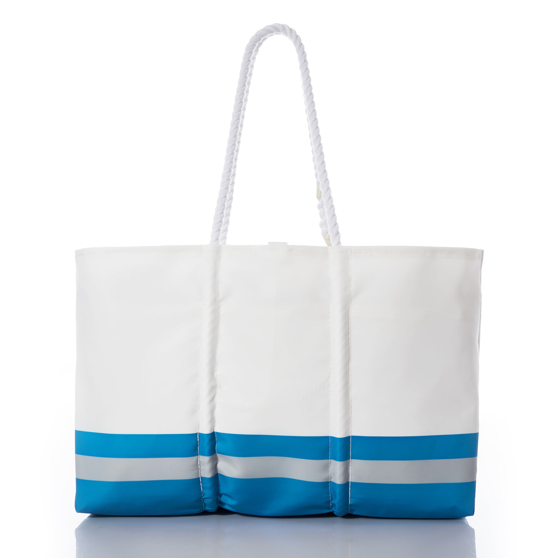 The Detroit Lions Tailgate Tote by Sea Bags is a white tote bag crafted from recycled sail cloth, featuring blue and gray horizontal stripes at the bottom and two long white rope handles. Photographed on a white background, this stylish and eco-friendly bag is perfect for showing your Lions Pride at your next football tailgate. by Sea Bags