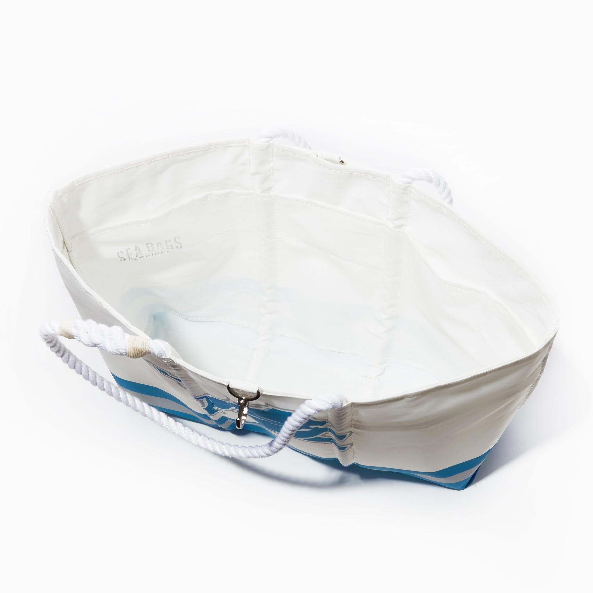 White and blue boat-shaped tote bag with rope handles, open at the top, viewed from above on a white background—this stylish Detroit Lions Tailgate Tote from Sea Bags is crafted from recycled sail cloth, making it both eco-friendly and perfect for your next football tailgate. by Sea Bags