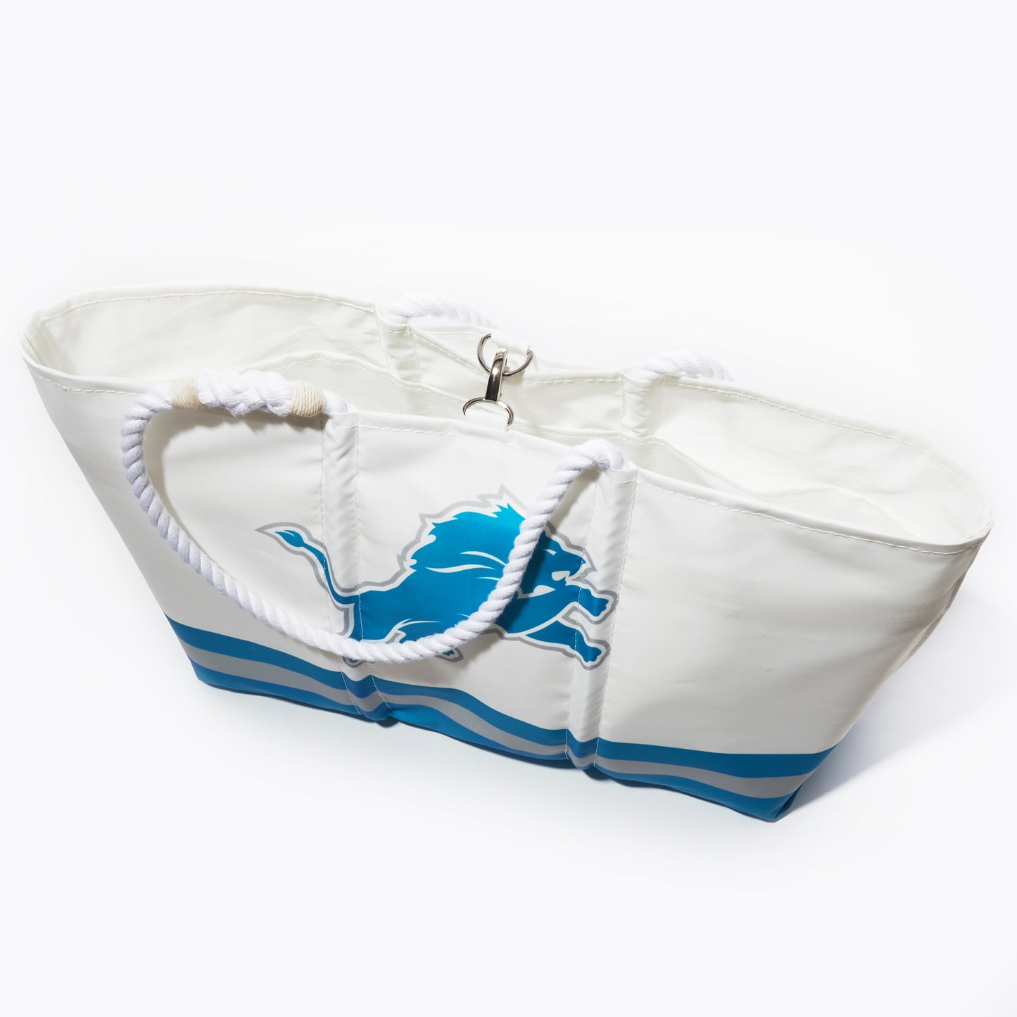 The Detroit Lions Tailgate Tote by Sea Bags features rope handles, blue stripes at the bottom, and a bold blue lion logo on the front. Photographed on a white background, its the perfect tote for your next football tailgate. by Sea Bags