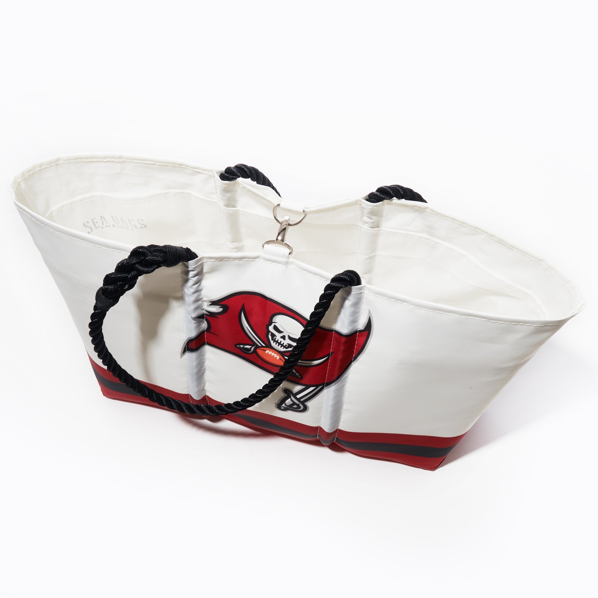 The Sea Bags Tampa Bay Buccaneers Tailgate Tote is a white recycled sail cloth bag featuring black rope handles and a striking Buccaneers logo on the front, photographed against a white background. Perfect as your go-to NFL accessory, this stylish tote lets you show your team pride at any tailgate or outing. by Sea Bags