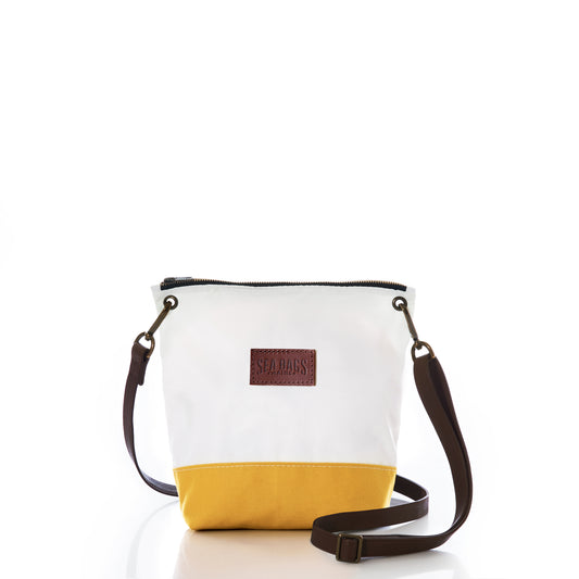 The Golden Yellow Chebeague Crossbody Bag by Sea Bags is a small white and yellow bag crafted from recycled sailcloth inspired by the Maine coast, featuring a brown adjustable strap and a brown leather patch on the front, displayed on a white background. by Sea Bags