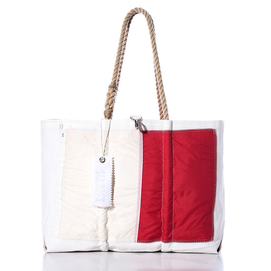 Sea Bags Hotel Signal Flag Large Tote, crafted from recycled sail cloth, features rope handles, a prominent red rectangular patch on the right side, and a white tag hanging from one handle. by Sea Bags