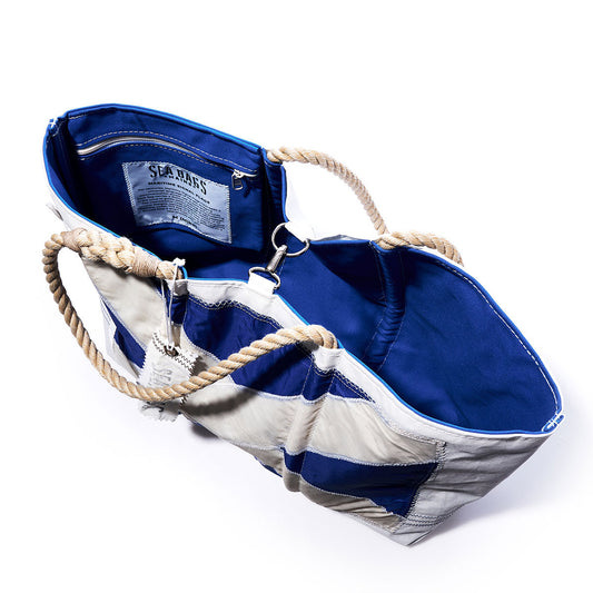 Sea Bags Mike Signal Flag Large Tote features blue and white recycled sail cloth with rope handles, an open design that reveals a blue interior lining, and a zippered pocket. by Sea Bags