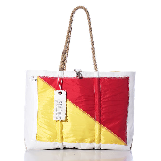 Oscar Signal Flag Large Tote by Sea Bags, crafted from recycled sail cloth and featuring a rope handle, showcases a diagonal red and yellow panel inspired by vintage signal flags. The white tote bag has a white tag labeled Sea Bags and is displayed against a plain white background. by Sea Bags