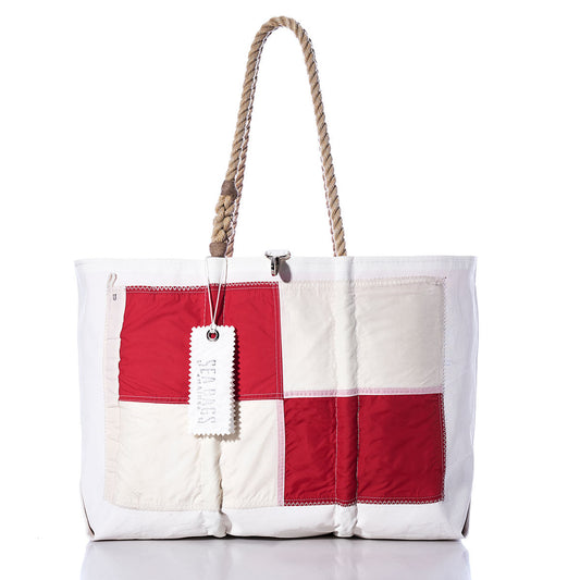 Uniform Signal Flag Large Tote by Sea Bags: A handcrafted white and red tote bag with a patchwork design inspired by maritime signal flags, featuring rope handles and a white tag labeled Sea Bags, made from vintage sail cloth, shown against a plain white background. by Sea Bags
