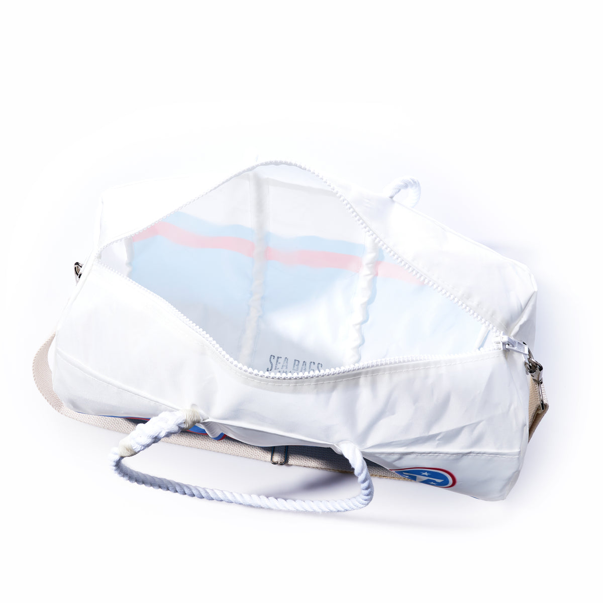 A Sea Bags Tennessee Titans Duffel, made from recycled sail cloth, features rope handles and a beige shoulder strap and is displayed unzipped to reveal its empty interior.