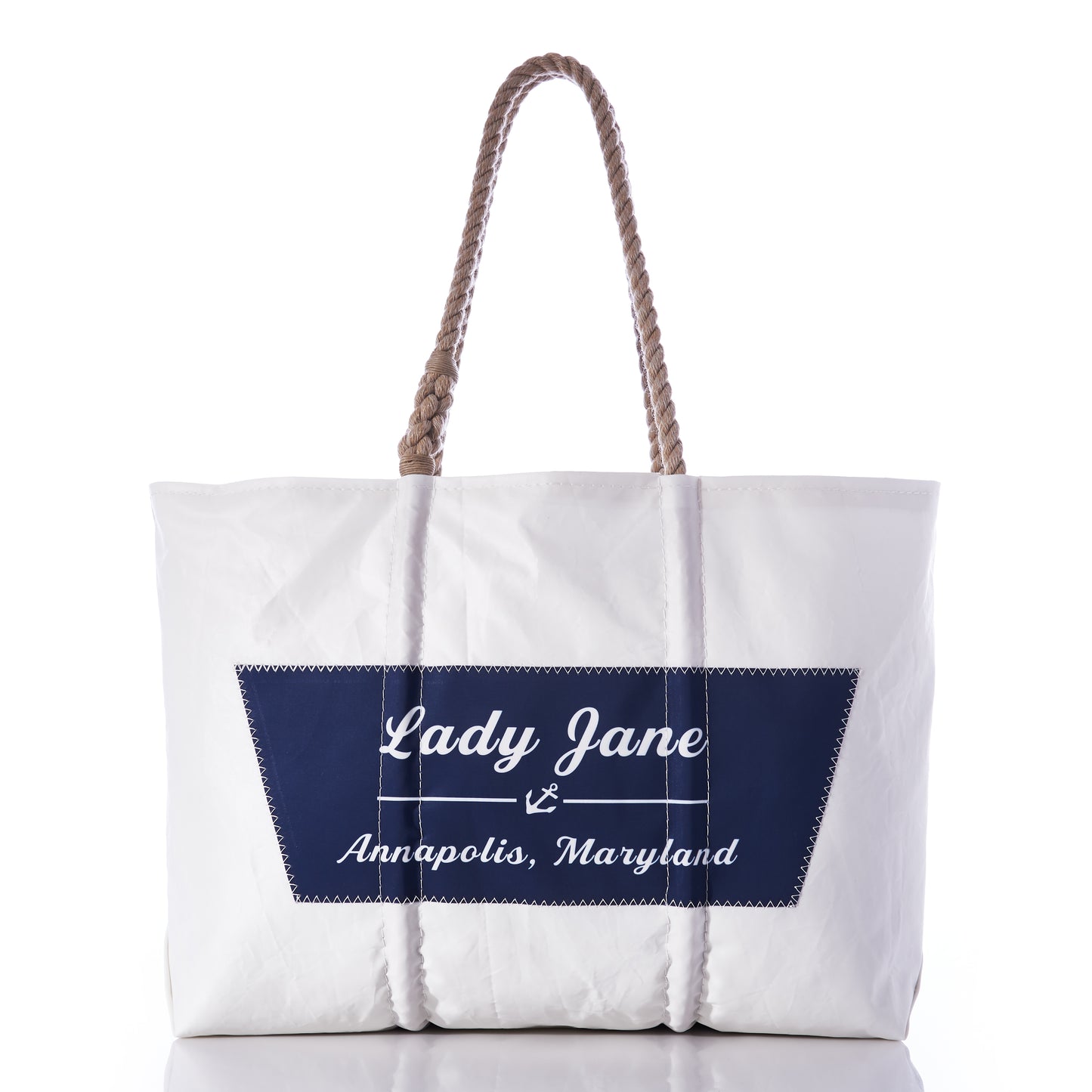 The Sea Bags Custom Boat Name Tote features sturdy rope handles and a navy blue patch on the front reading “Lady Jane, Annapolis, Maryland”—the perfect personalized accessory to bring nautical style to your daily adventures. by Sea Bags