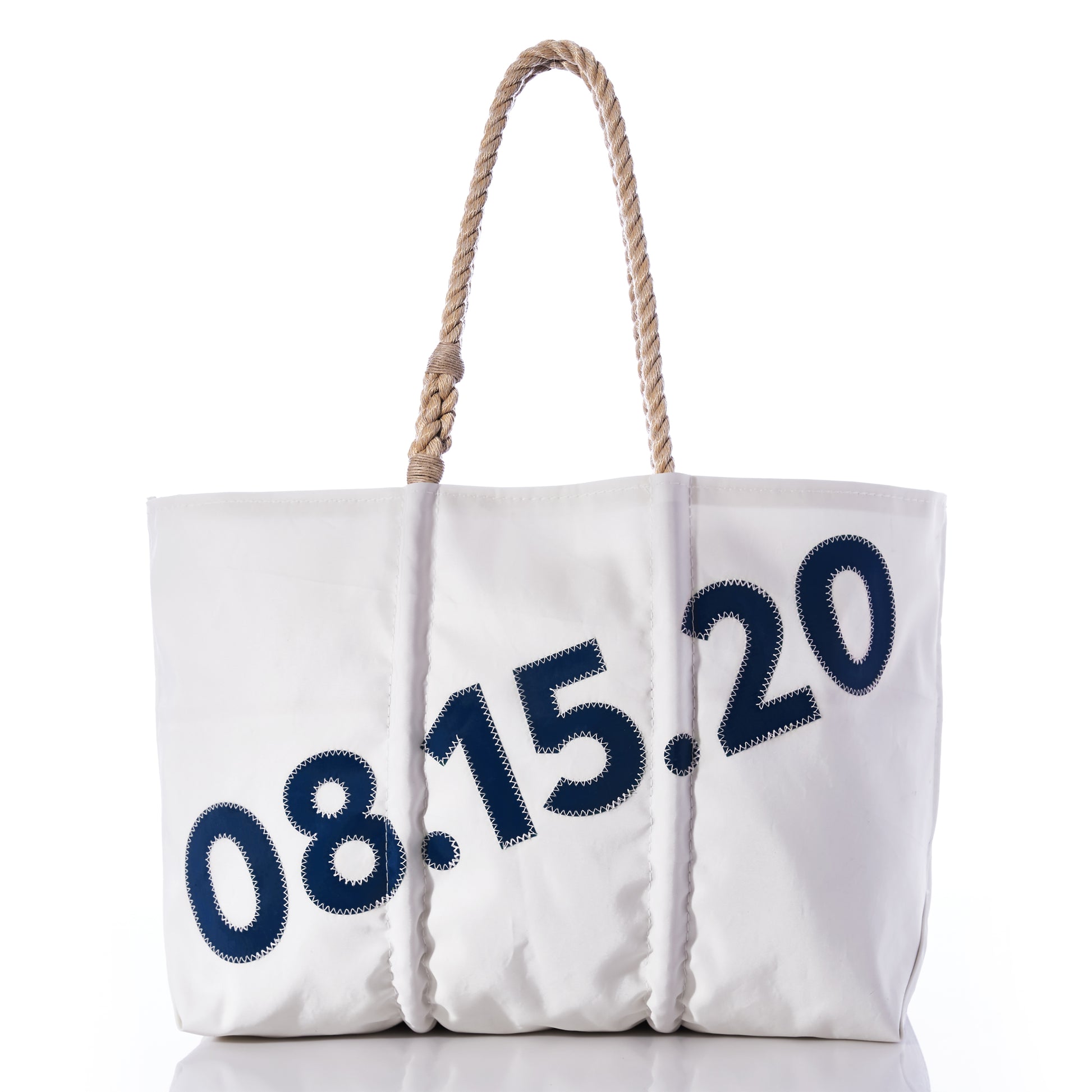 Sea Bags’ Custom Date Tote is a white tote bag with rope handles, showcasing the date 08.15.20 in bold blue numbers on the front—a perfect way to mark special occasions. Personalize your Sea Bags Custom Date Tote further by adding a custom message patch to create a truly unique keepsake. by Sea Bags