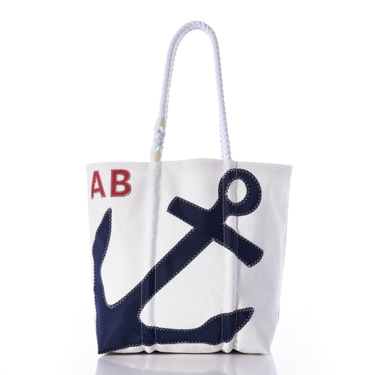 Sea Bags Custom Monogram Anchor Tote—crafted from recycled sailcloth, this stylish white tote features a blue anchor graphic, bold red monogrammed initials, and sturdy white rope handles. Displayed on a plain white background, it’s the perfect personalized gift or custom anchor tote for any occasion. by Sea Bags