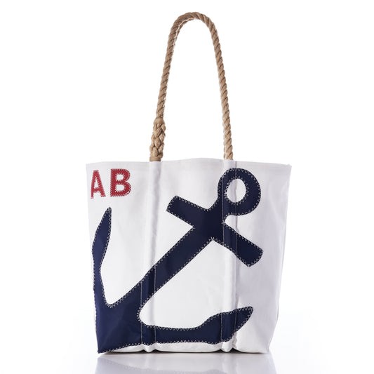 Introducing the Sea Bags Custom Monogram Anchor Tote—a white tote bag made from recycled sailcloth, designed with sturdy rope handles. It showcases a bold navy blue anchor on the front and personalized red initials AB in the upper left corner. This eco-friendly anchor tote provides a unique and thoughtful gift for any occasion. by Sea Bags
