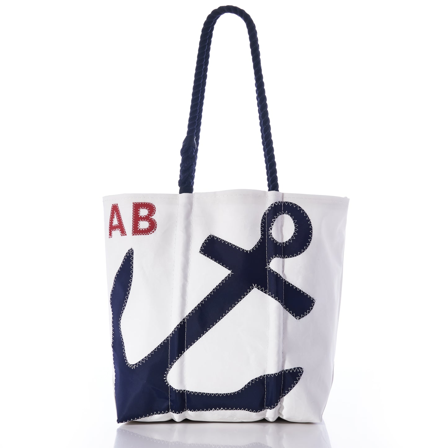 Sea Bags Custom Monogram Anchor Tote: A white tote bag with navy blue rope handles, featuring a large stitched navy anchor and red-stitched initials “AB” in the upper left corner—expertly crafted from recycled sailcloth for a unique personalized gift. by Sea Bags