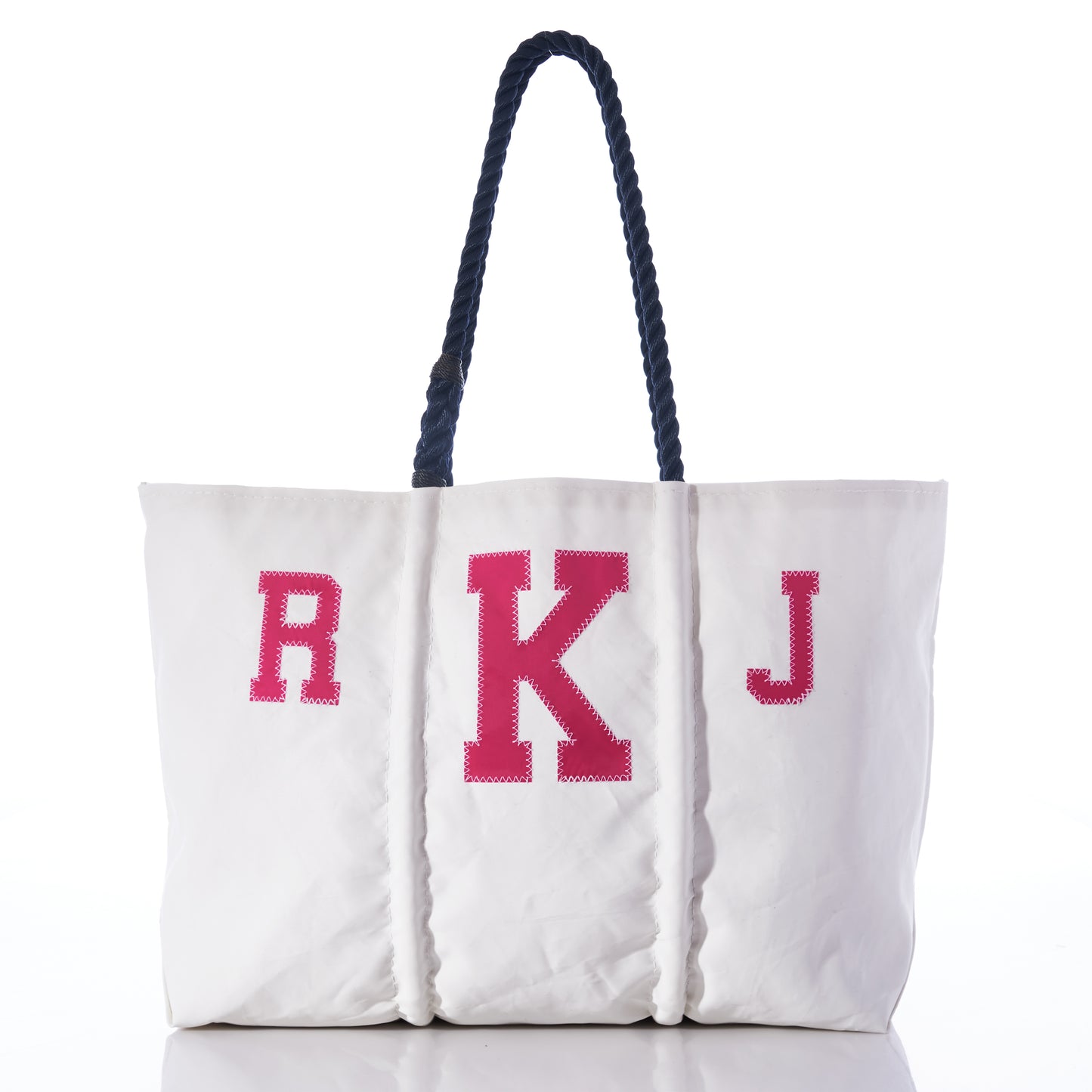 The Sea Bags Custom Monogram Tote is a white tote made from recycled sail cloth, featuring two dark rope handles and a personalized pink R K J monogram on the front—an ideal everyday accessory. by Sea Bags