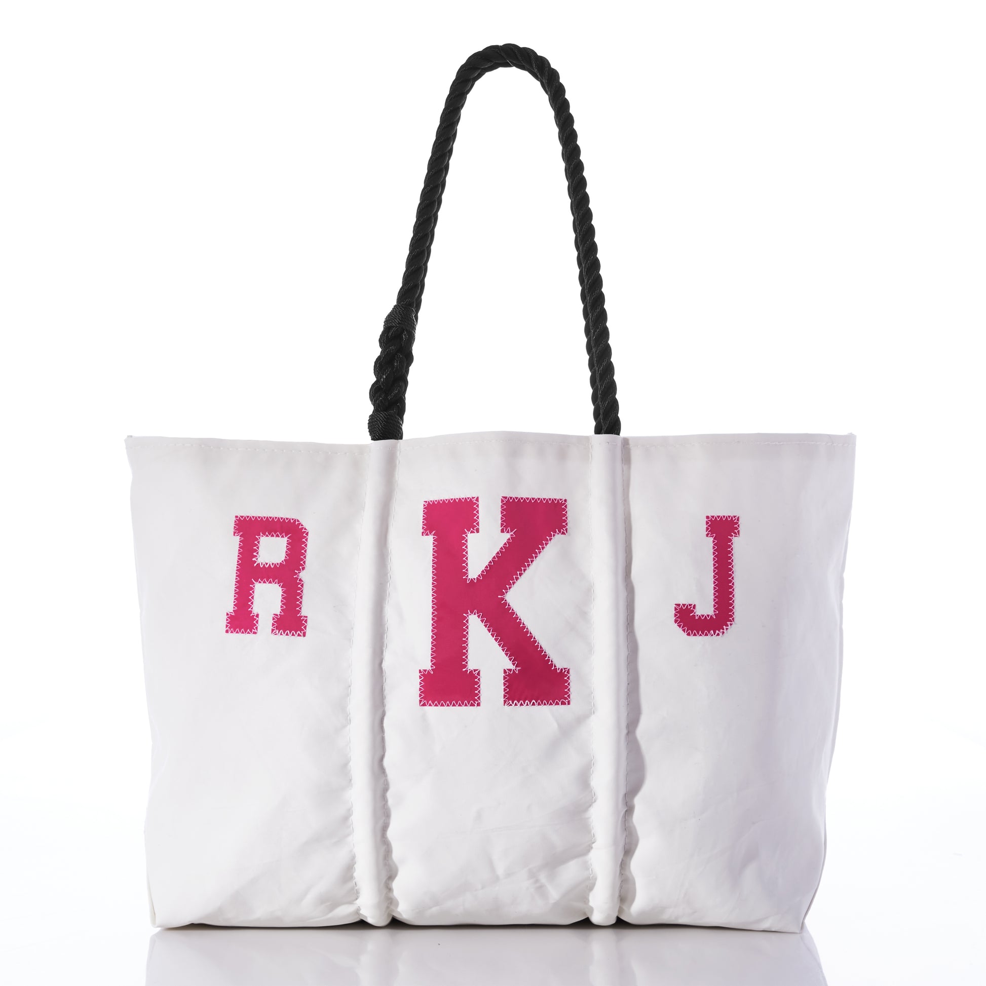 Introducing the Custom Monogram Tote by Sea Bags—a white tote bag made from recycled sail cloth, featuring black rope handles and a bold pink R K J monogram on the front. Photographed against a white background, this stylish accessory is perfect for personalization. by Sea Bags