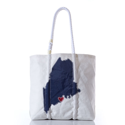 Introducing the Custom Maine Tote by Sea Bags—a white tote bag with durable rope handles, showcasing a navy blue outline of Maine and a charming red heart near the southern coast. This personalized Sea Bags tote is the perfect Maine gift or everyday accessory for anyone who treasures the Pine Tree State. by Sea Bags