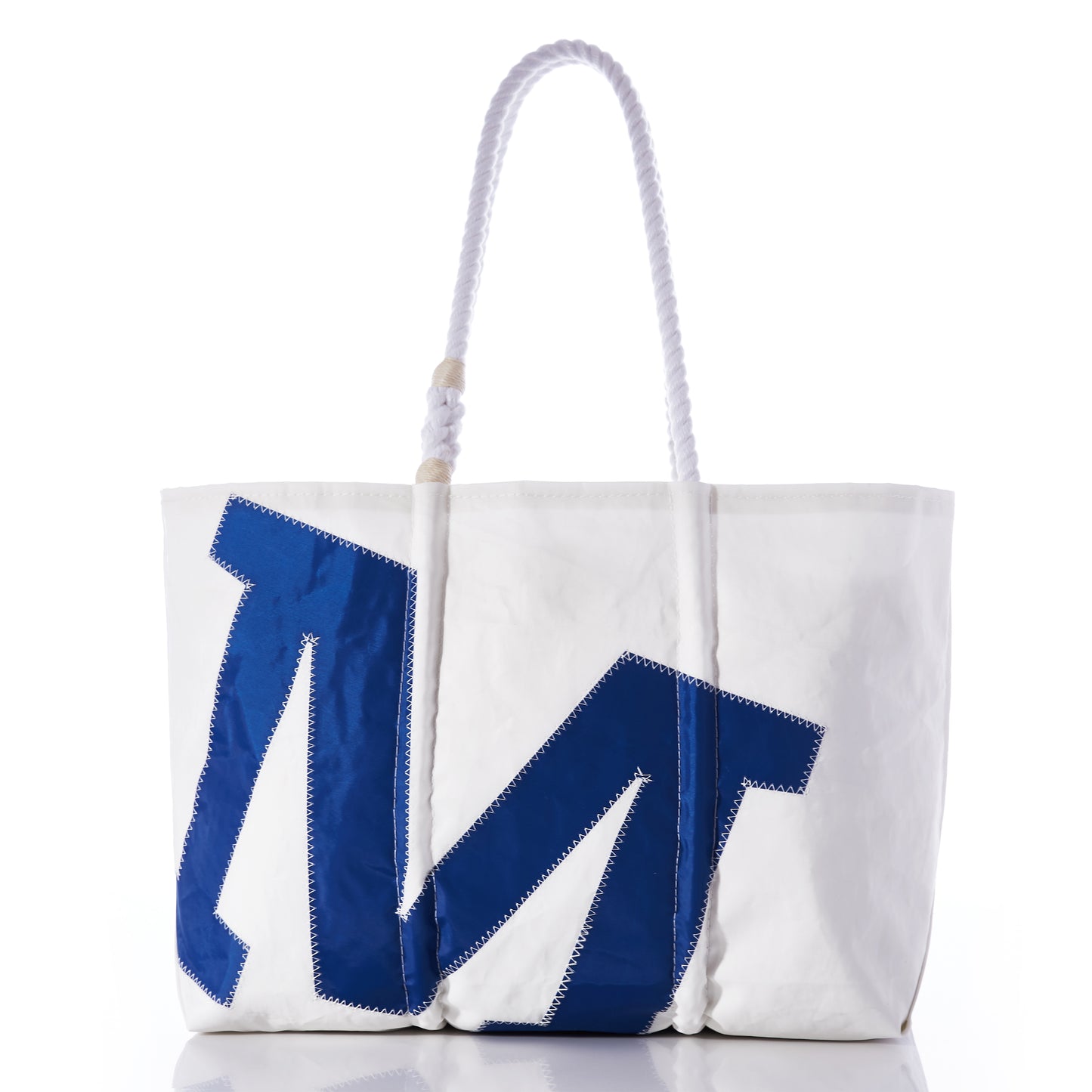 Introducing the Sea Bags Custom Single Letter Large Tote: a white canvas tote bag with sturdy rope handles, adorned with a striking blue M patch stitched prominently on the front. by Sea Bags