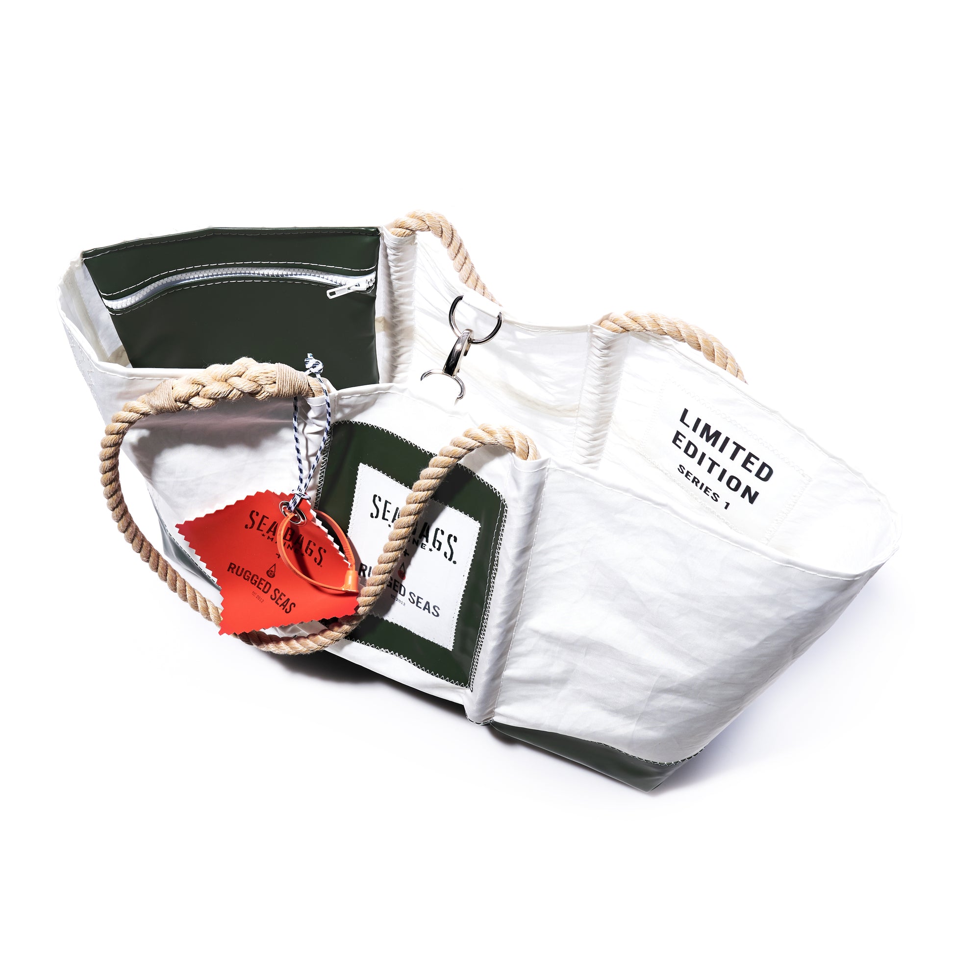Trapline Large Tote - Dark Green by Sea Bags: a white and dark green recycled sail cloth tote featuring rope handles, a zippered pocket, a Limited Edition label, and an orange tag reading Sea Bags—an ocean-inspired bag handcrafted in the tradition of Maine lobster fishermen. by Sea Bags