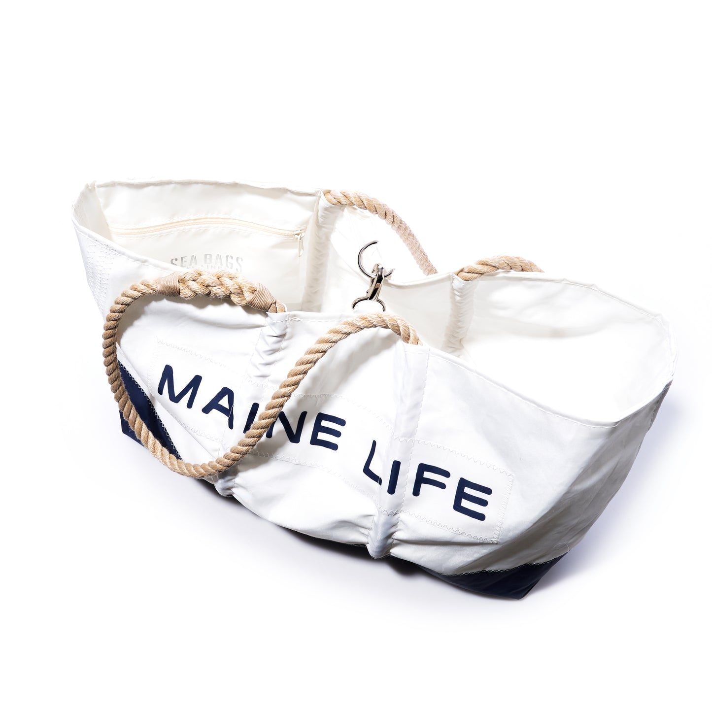 The Sea Bags Maine Life Large Tote, designed by Erin Ovalle, features navy MAINE LIFE lettering, sturdy rope handles, and an open top. Photographed on a white background. by Sea Bags