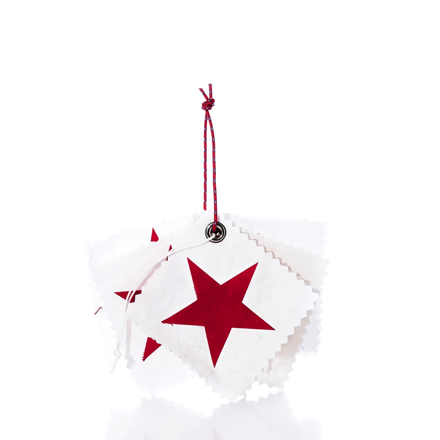 A set of five white square Sea Bags Sail Cloth Gift Tags, each adorned with a red star and crafted from sustainable recycled sail material, are stacked and tied together with a red and white string against a white background. by Sea Bags