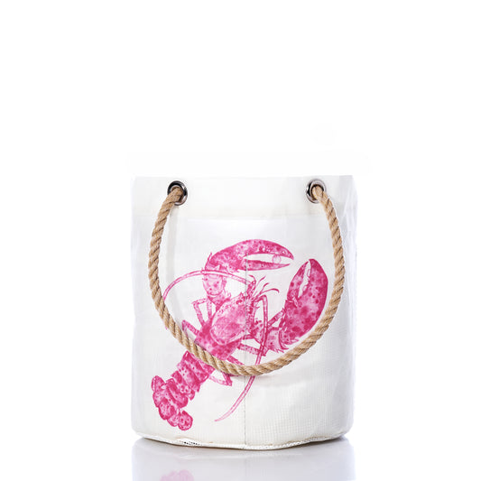 The Sea Bags Pink Lobster Beachcomber Bucket is crafted from recycled sail cloth and features a pink lobster print on the front, sturdy rope handles, and is shown on a white background. by Sea Bags