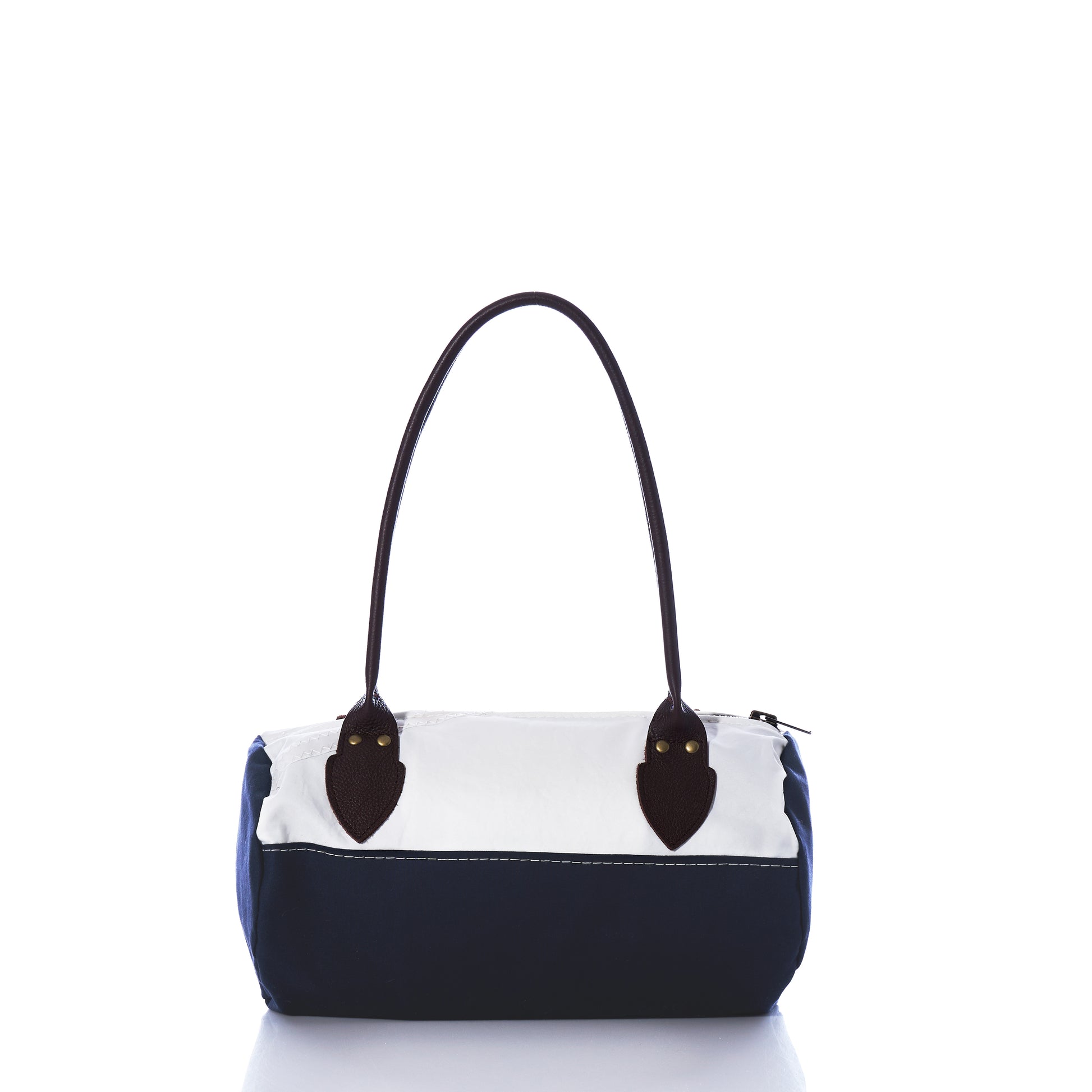 The Chebeague Baguette Bag by Sea Bags features a two-tone design with a white upper section, navy blue lower section, dark handles, and a zipper closure, displayed on a white background. by Sea Bags
