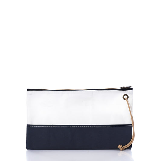 The Sea Bags Navy Chebeague Large Wristlet is a rectangular pouch made from reclaimed sailcloth, showcasing a white upper panel and dark blue lower section. It features a zipper closure and a tan cord loop on the right side, all set against a white background. This wristlet exemplifies sustainable style through its thoughtful use of upcycled materials. by Sea Bags