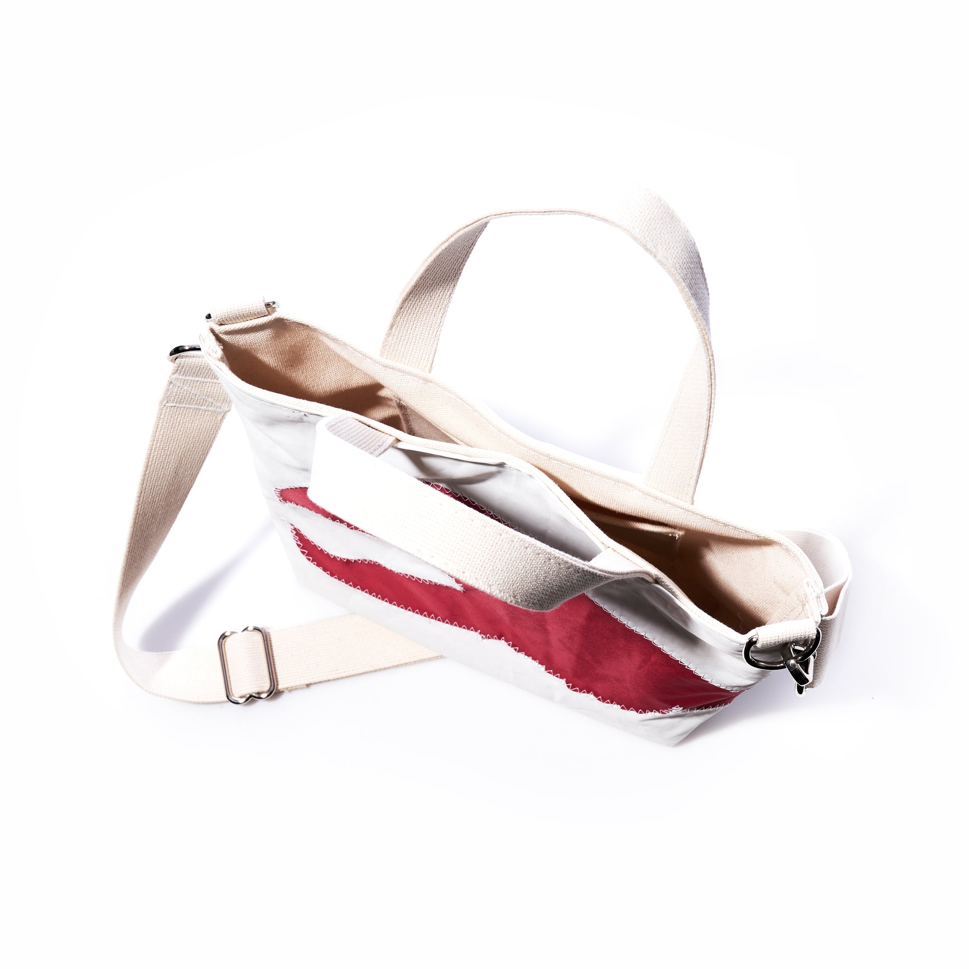 Sea Bags Red Lobster Claw Crossbody Tote is an eco-friendly white canvas bag featuring an adjustable strap and a bold red lobster claw design on the front, shown against a white background. by Sea Bags