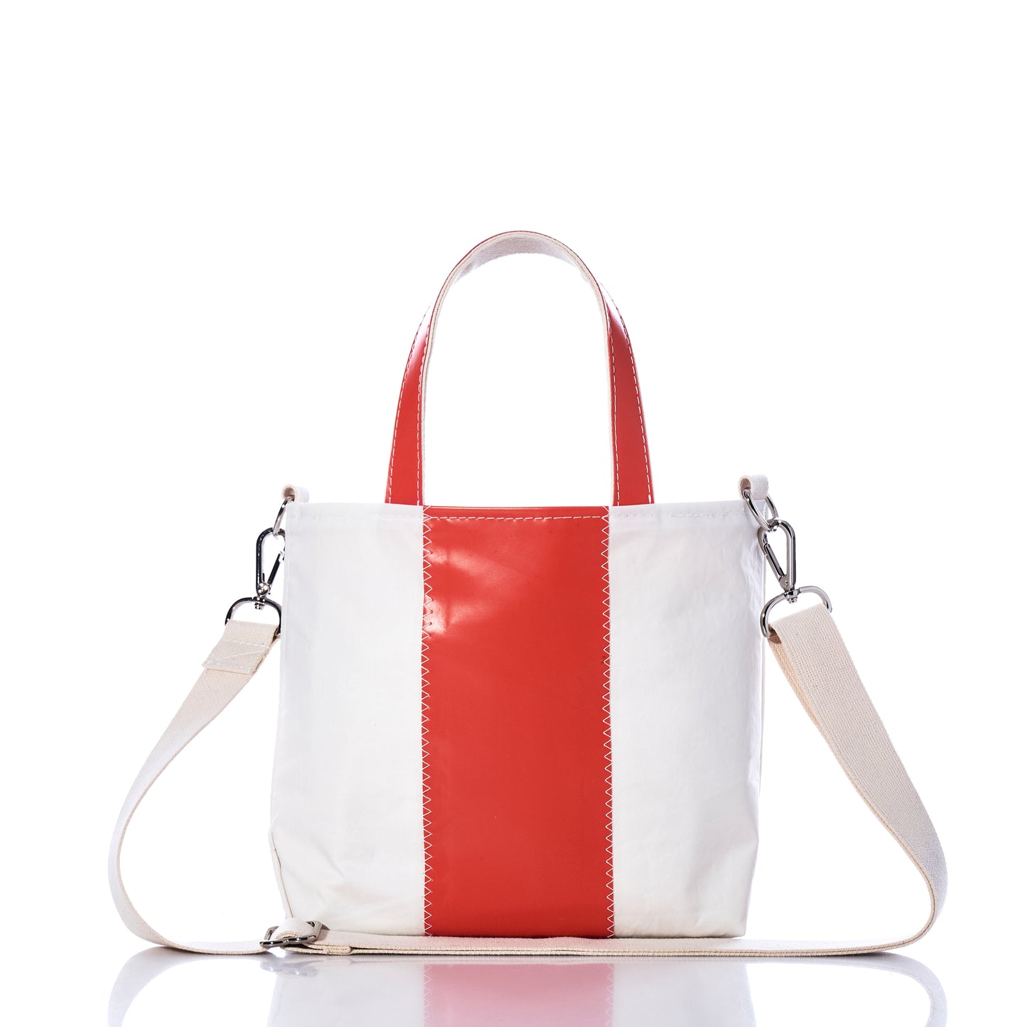 The Trapline Crossbody Tote by Sea Bags is a sustainable white handbag featuring a central vertical red stripe, two short handles, and a detachable beige shoulder strap, displayed on a white background—thoughtfully designed for both style and eco-consciousness. by Sea Bags