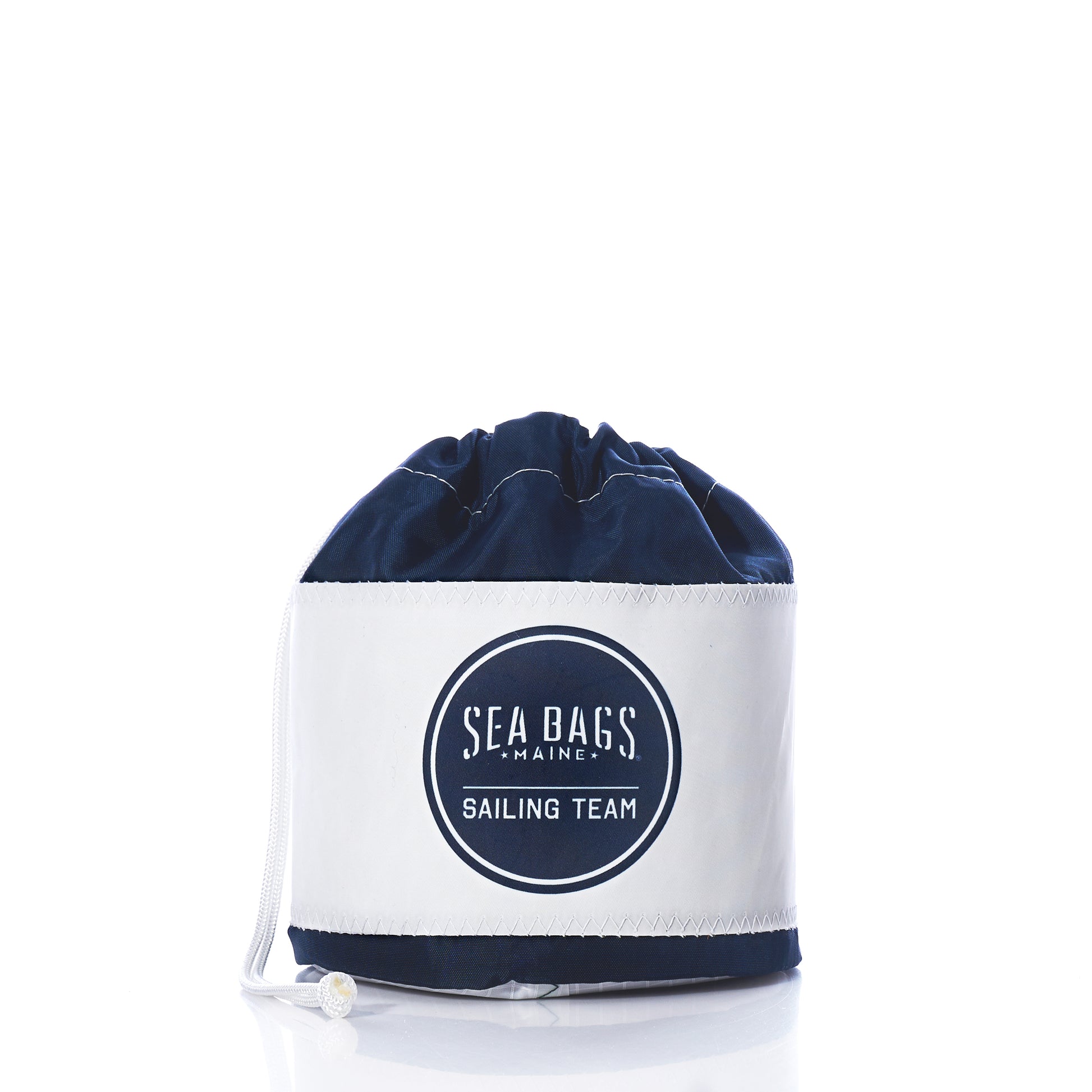 Introducing the Race Day Ditty Bag by Sea Bags—a stylish drawstring sailing bag crafted from recycled sail bags. Featuring a bold Sailing Team logo on the front, this accessory showcases a crisp white base and navy top, beautifully photographed on a clean white background. by Sea Bags