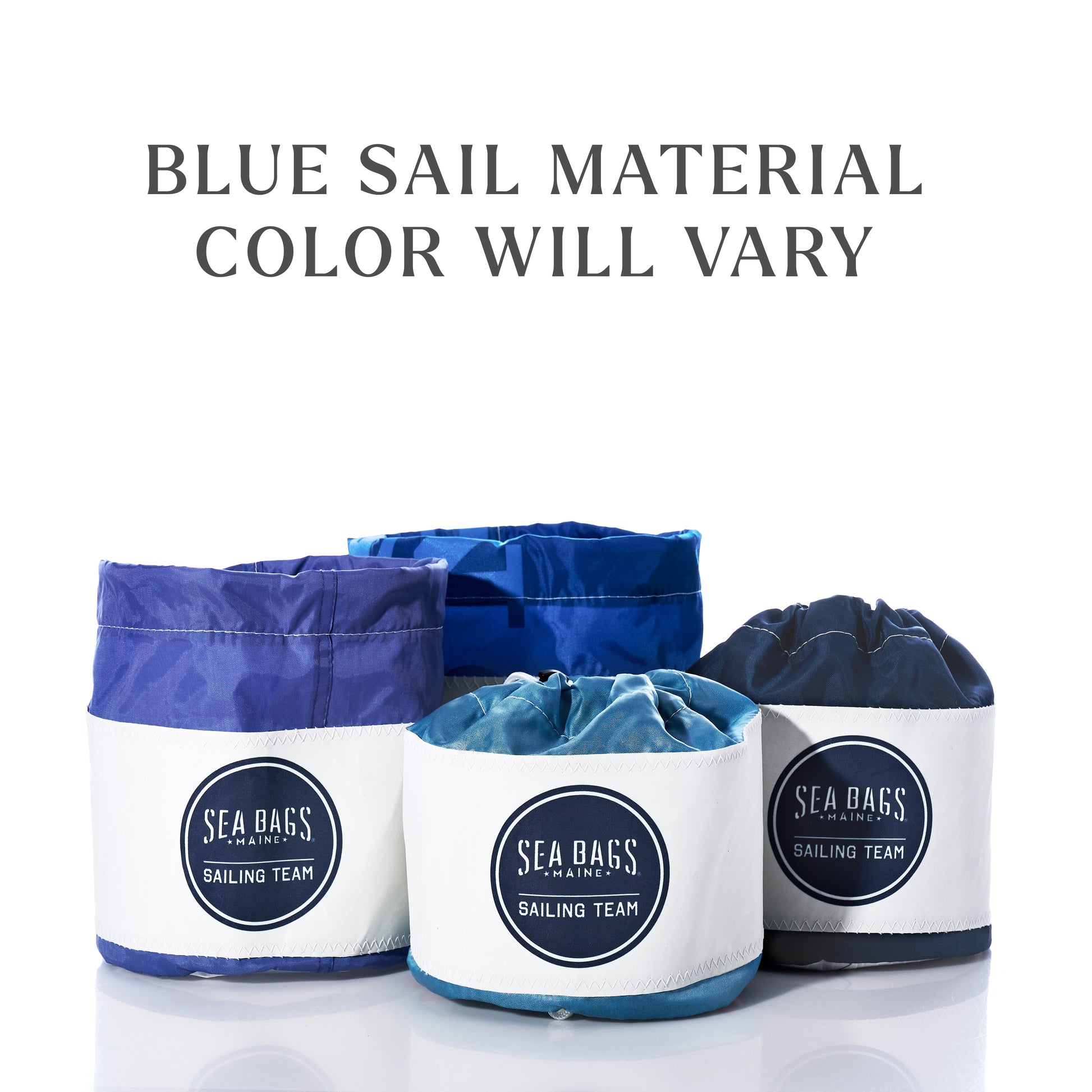 Four Sea Bags Race Day Ditty Bags crafted from recycled blue sail material, each featuring a distinctive shade and pattern, displayed against a white background. Text above reads “Blue sail material color will vary.”. by Sea Bags